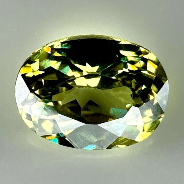 0.46 carat natural demantoid garnet from Namibia, bright green color, eye-clean clarity, and exceptional brilliance.