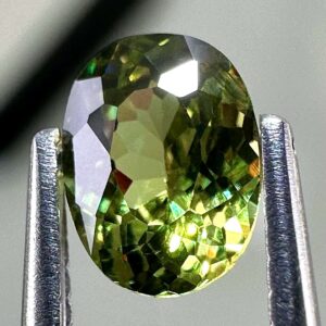 0.46 carat natural demantoid garnet from Namibia, bright green color, eye-clean clarity, and exceptional brilliance.