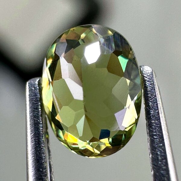 0.46 carat natural demantoid garnet from Namibia, bright green color, eye-clean clarity, and exceptional brilliance.