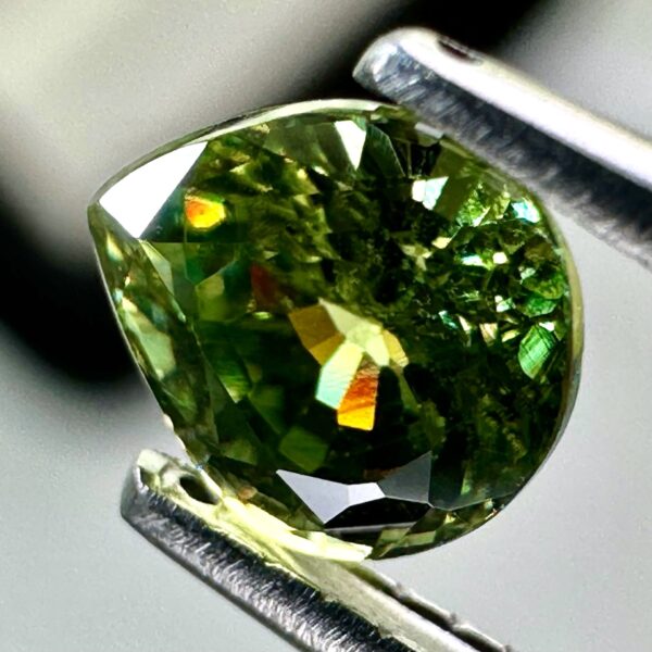 0.43 carat natural demantoid garnet from Namibia, bright green color, and excellent clarity.