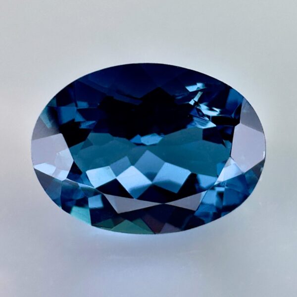 High quality 3.22ct oval shaped London Blue Topaz with a deep blue hue, luminous brilliance and excellent clarity - perfect for fine jewelry designs.