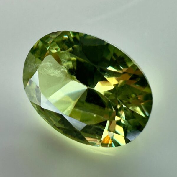 0.40 carat natural demantoid garnet from Namibia, very bright green color, oval cut, and untreated.