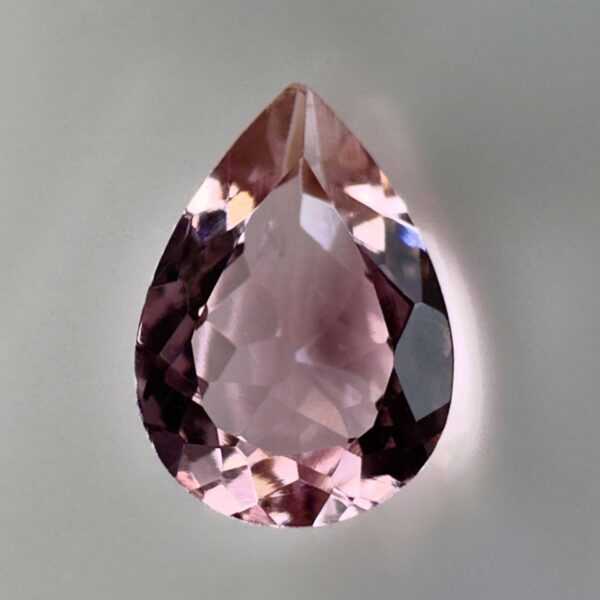 Pink tourmaline gemstone, 0.58 carat, pear-shaped cut, rare salmon pink color, beautiful clarity, and brilliant shine.
