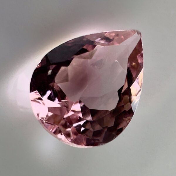 Pink tourmaline gemstone, 0.58 carat, pear-shaped cut, rare salmon pink color, beautiful clarity, and brilliant shine.