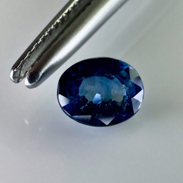 Natural blue sapphire 0.87 ct, oval cut, navy blue color, Thailand origin, jewelry quality gemstone with very few inclusions.